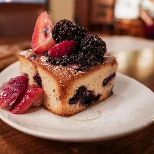 a piece of cake with berries on top