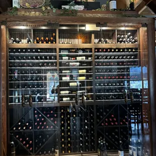 Killer wine cellar at the front door entrance. Bar to right, dining room to left.