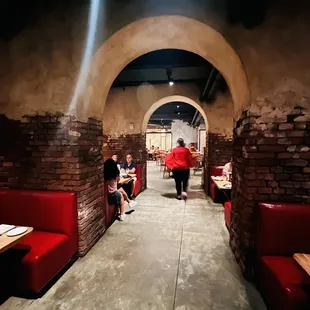 a man walking through the tunnel