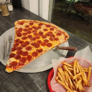 Giant pepperoni slice and French fries