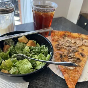 Half Caesar salad and a slice. I added mushrooms. Fresh seasonings on table.