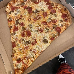 Giant slice of pepperoni and Italian sausage with extra cheese! OMG real NY pizza heaven on a slice. HUGE!