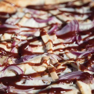 a pizza covered in bbq sauce