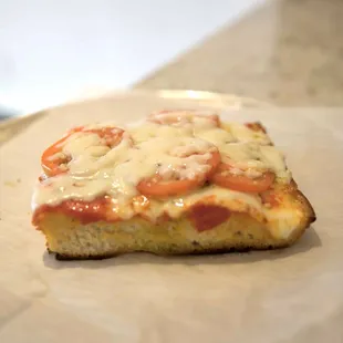 a slice of pizza on a plate