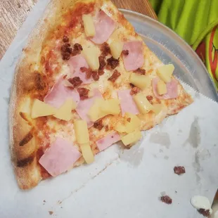 a slice of ham and pineapple pizza