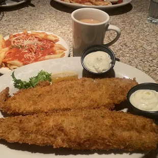 Fried Haddock fish dinner with a side of pasta.