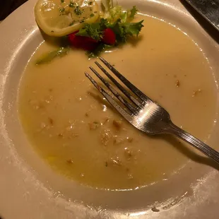 a plate of soup with a fork