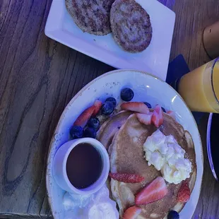 Blueberry waffles with a side of eggs (not listed) and sausage