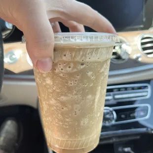 a hand holding a cup of coffee
