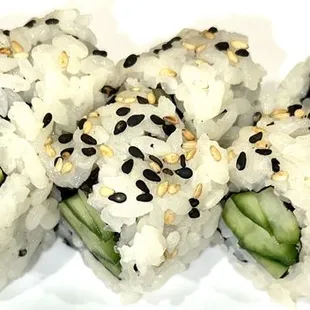 four pieces of sushi on a white plate