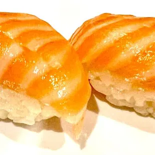 two pieces of sushi on a white plate