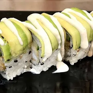 a close up of a roll with avocado