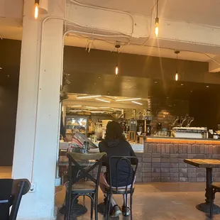 a woman sitting at a table in a restaurant