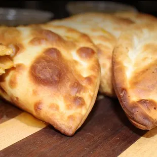 a close up of a meat and vegetable empanada