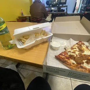 The 1topping alive of pizza (sausage), fries and a drink special with a side order of ranch.