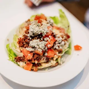 THE ICEBERG EPIC WEDGE
Crisp Iceberg Lettuce, Topped with Bacon, Tomatoes, Danish Bleu Crumbles, &amp;
European Bleu Cheese Dressing