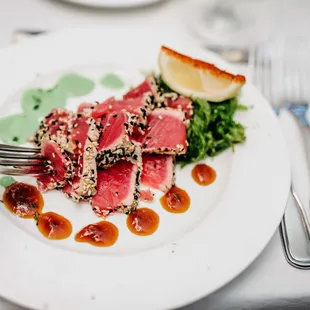 RARE SEARED AHI TUNA
Sesame Crusted Tuna Seared Rare with Nori Salad, Kyoto &amp; Wasabi Drizzles