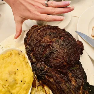 (Hand for size comparison AND my lady has such lovely hands and an epic ring) Epic 48 Ounce Long-bone Tomahawk Ribeye