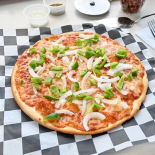 a pizza on a checkered tablecloth