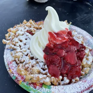 a waffle topped with whipped cream and strawberries