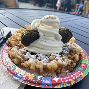 a waffle topped with whipped cream and oreos