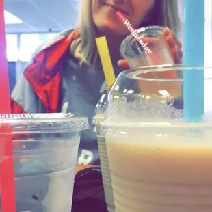 a woman sitting at a table with drinks
