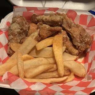 a basket of fried chicken and french fries