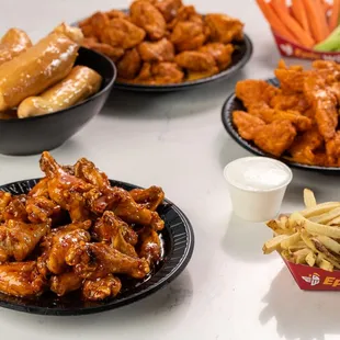 a variety of wings and fries