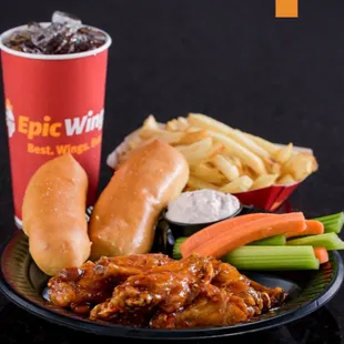 a plate of wings, carrots, celery, and fries