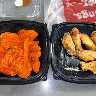 two trays of fried chicken and carrots
