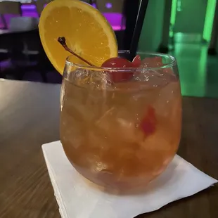 a drink in a glass on a napkin