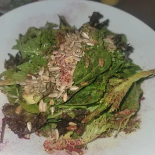 Esalada: mixed greens, hearts of palm, onion, &amp; toasted sunflower seeds tossed w/ mandarin-chive dressing