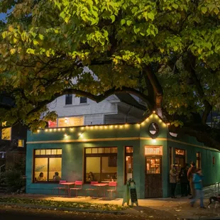 The restaurant is in a cool little building, with a beautiful tree on the corner