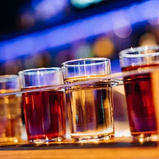 a row of shot glasses on a bar