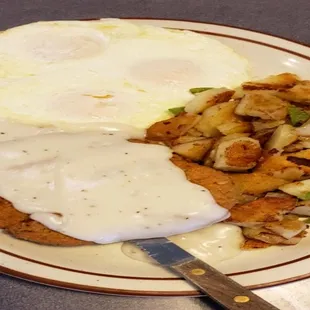 a plate of food with eggs and hash browns