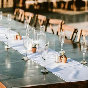 Farm tables with cross back chairs.