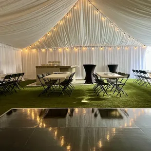 dance floor under a draped frame tent