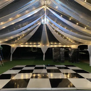 market lights with draping and on a clear-top tent