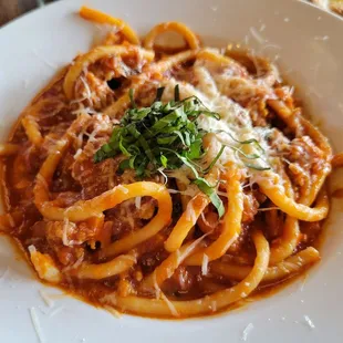 a plate of pasta with sauce and parmesan cheese