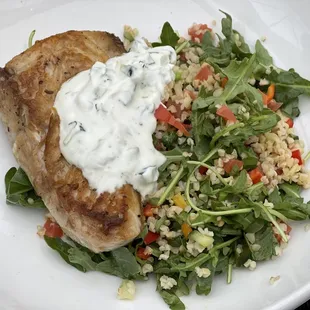 Mahi mahi on a bed of arugula and bulgar