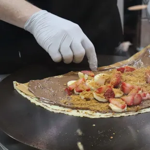 a person making a crepe