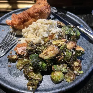 Fried chicken with mashed potatoes and Brussels sprouts.