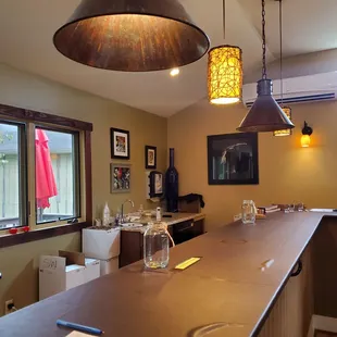 a bar with a wine glass on the counter