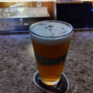 a glass of beer sitting on a table