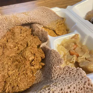 a plate of food in a styrofoam container