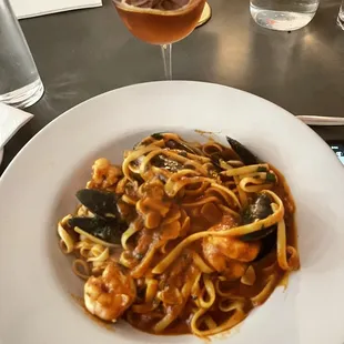 a plate of pasta and a glass of wine
