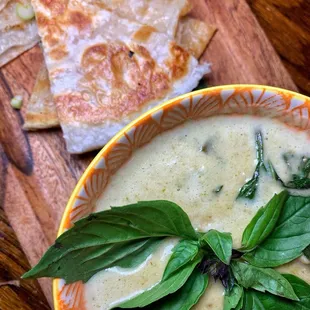 a bowl of soup and tortillas