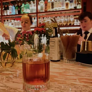 a bartender pouring a drink at a bar