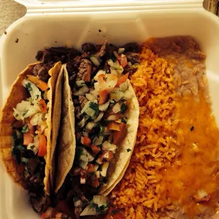 1 soft carne Asada taco( no guac)  1 hard carne Asada taco (no guac). W/ rice and beans