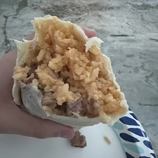 a person holding a burrito